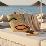 Woven Straw Market Tote Bag with Embroidered Winking Face Design